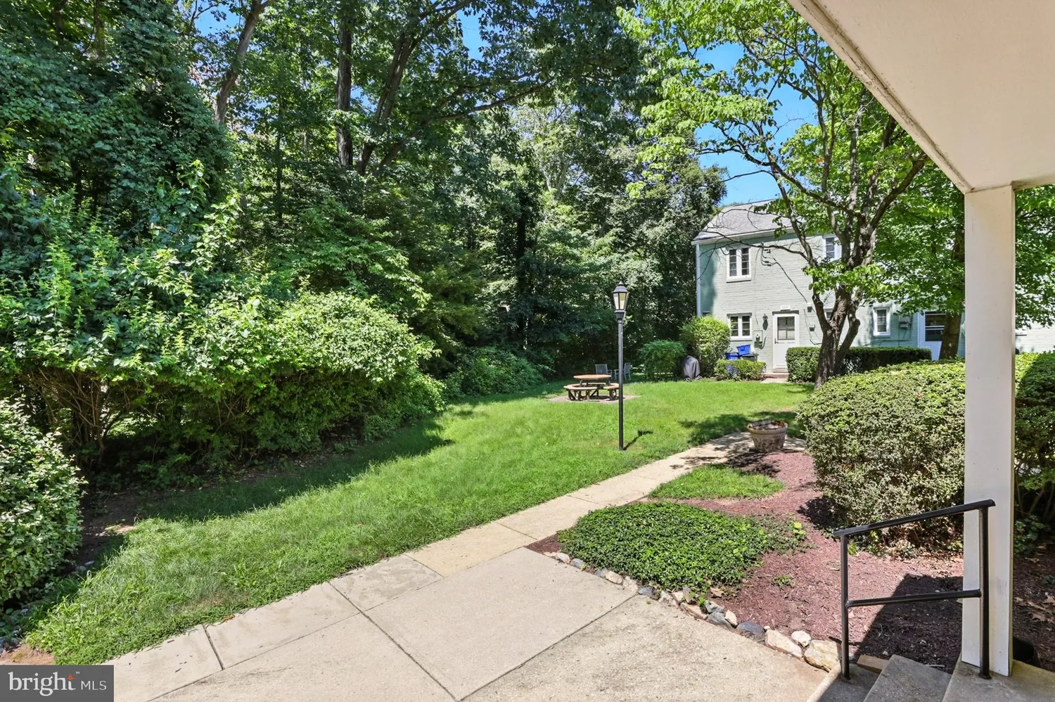 Tree-lined path from street access toward 9882 Hollow Glen Place